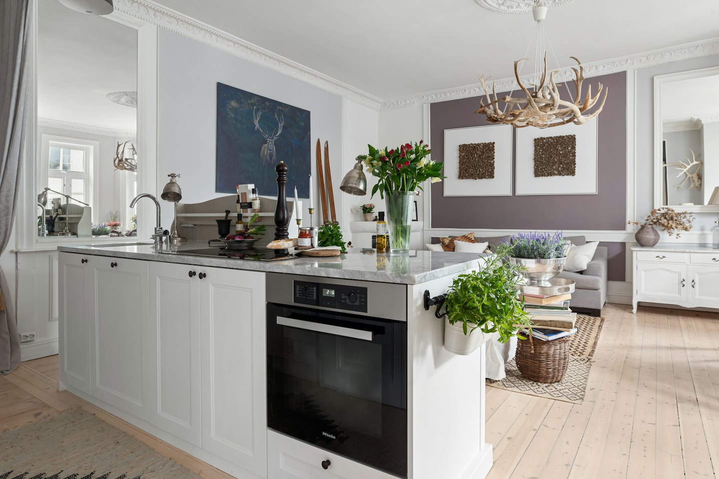 Modern open plan kitchen and living area with elegant decor.