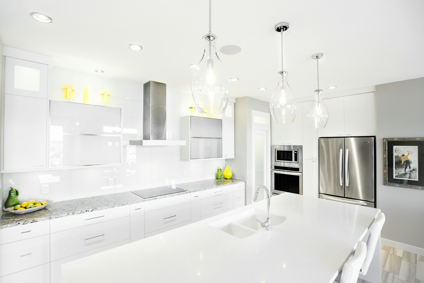 Modern kitchen with white cabinets and a large island.